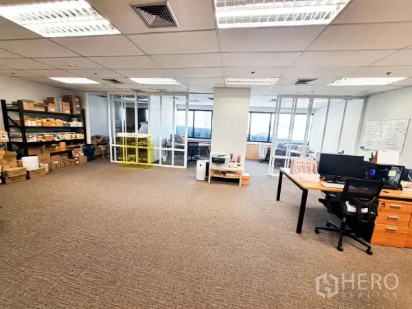 Office Space for rent in Bang Na, Bangkok - Large office floor with shelving storage, printers and glass meeting rooms overlooking city views.