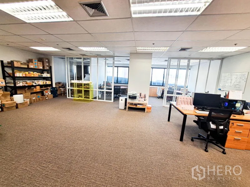 Office Space for rent in Bang Na, Bangkok - Large office floor with shelving storage, printers and glass meeting rooms overlooking city views.