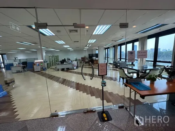Office Space for rent in Khlong Toei, Bangkok - Glass double-door entrance leading to a bright office with herringbone flooring and panoramic park and city views.