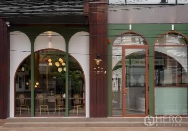 Retail Space for rent in Watthana, Bangkok - Street-facing retail facade with large arched glass windows and wooden door.
