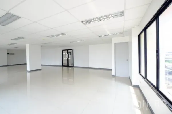 Office Space for rent in Chatuchak, Bangkok - Corner office area filled with natural light and ceiling fluorescent fixtures.