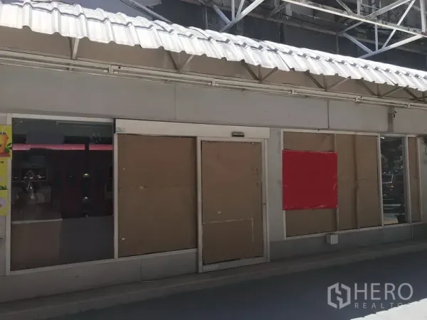 Retail Space for rent in Watthana, Bangkok - Street-facing retail unit with glass storefront and covered walkway under a white metal awning.