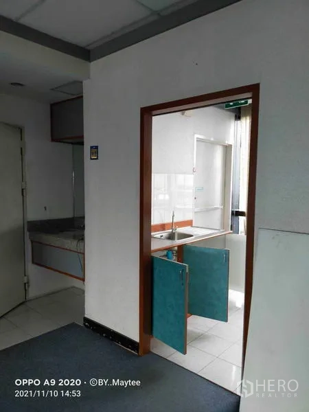 Office Space for rent in Watthana, Bangkok - Pantry area with sink, tiled floor and swing doors adjacent to the workspace.