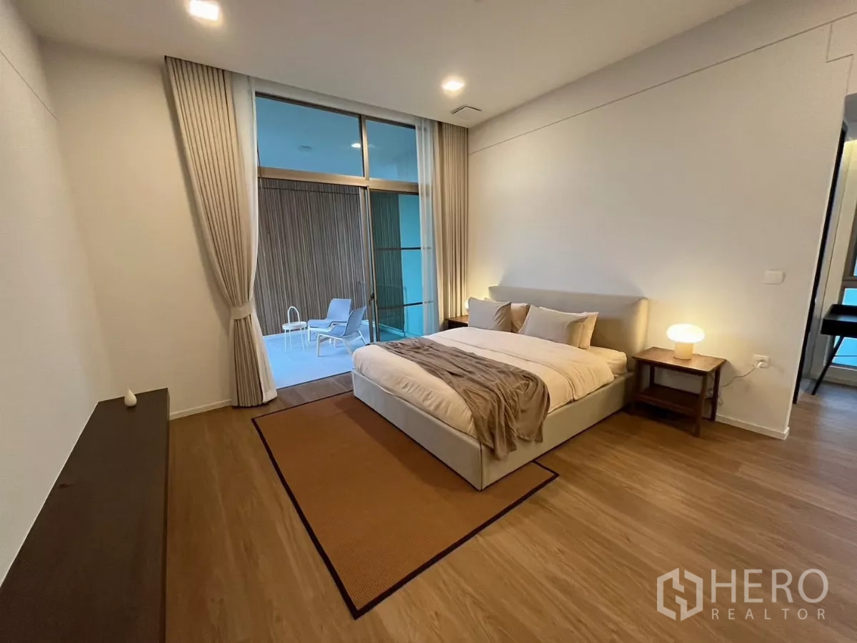 Detached House for rent in Saphan Sung, Bangkok - Spacious master bedroom with king bed opening to a private terrace, warm bedside lighting.