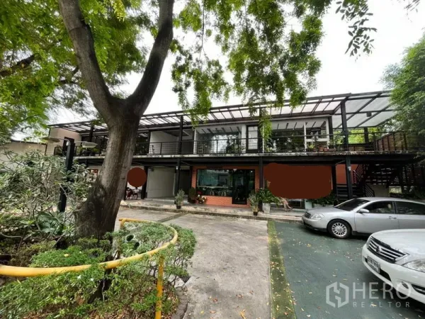 Retail Space for rent in Watthana, Bangkok - Two-storey modern retail complex with glass frontage, covered walkways, mature trees and on-site parking in Watthana, Bangkok.