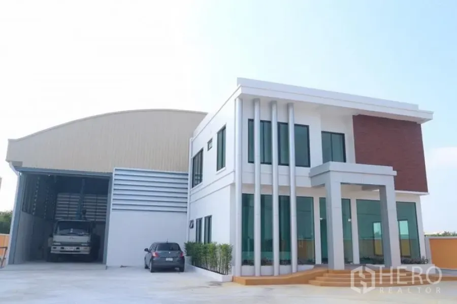 Factory for sale in Bang Pakong, Chachoengsao - Modern two-storey office attached to a warehouse with parking yard and truck bay.