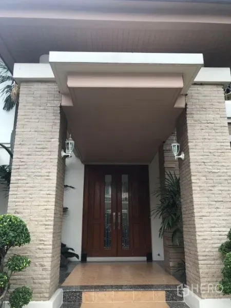 Detached House for rent in Bang Phli, Samut Prakan - Grand front porch with brick columns, wooden double doors and wall lanterns.