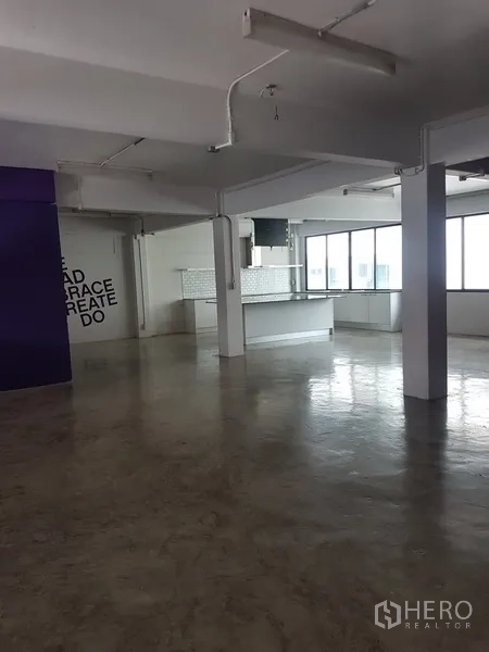 Home Office for sale in Khlong Toei, Bangkok - Open workspace with polished concrete, purple accent wall and a pantry counter.