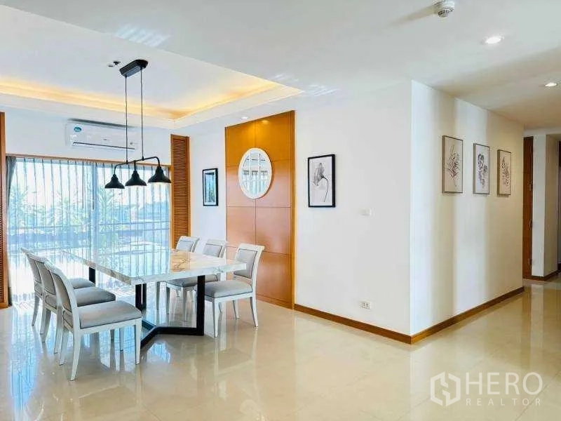 Apartment for rent - Bright dining space with large windows, three pendant lights and white dining set.
