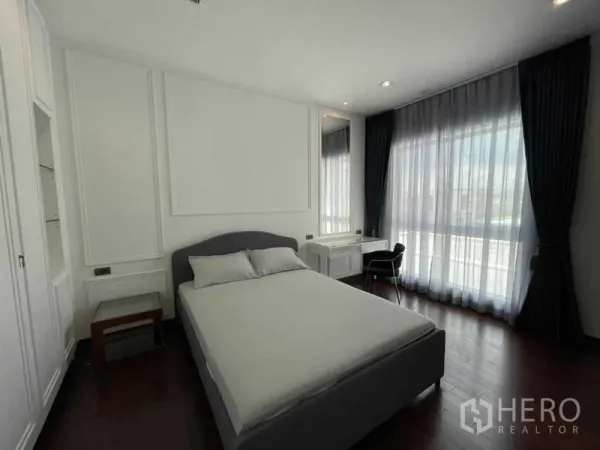 独立式住宅 出租或出售在Lat Krabang, Bangkok - 采光充足的卧室，双人床与窗边书桌，落地窗帘。