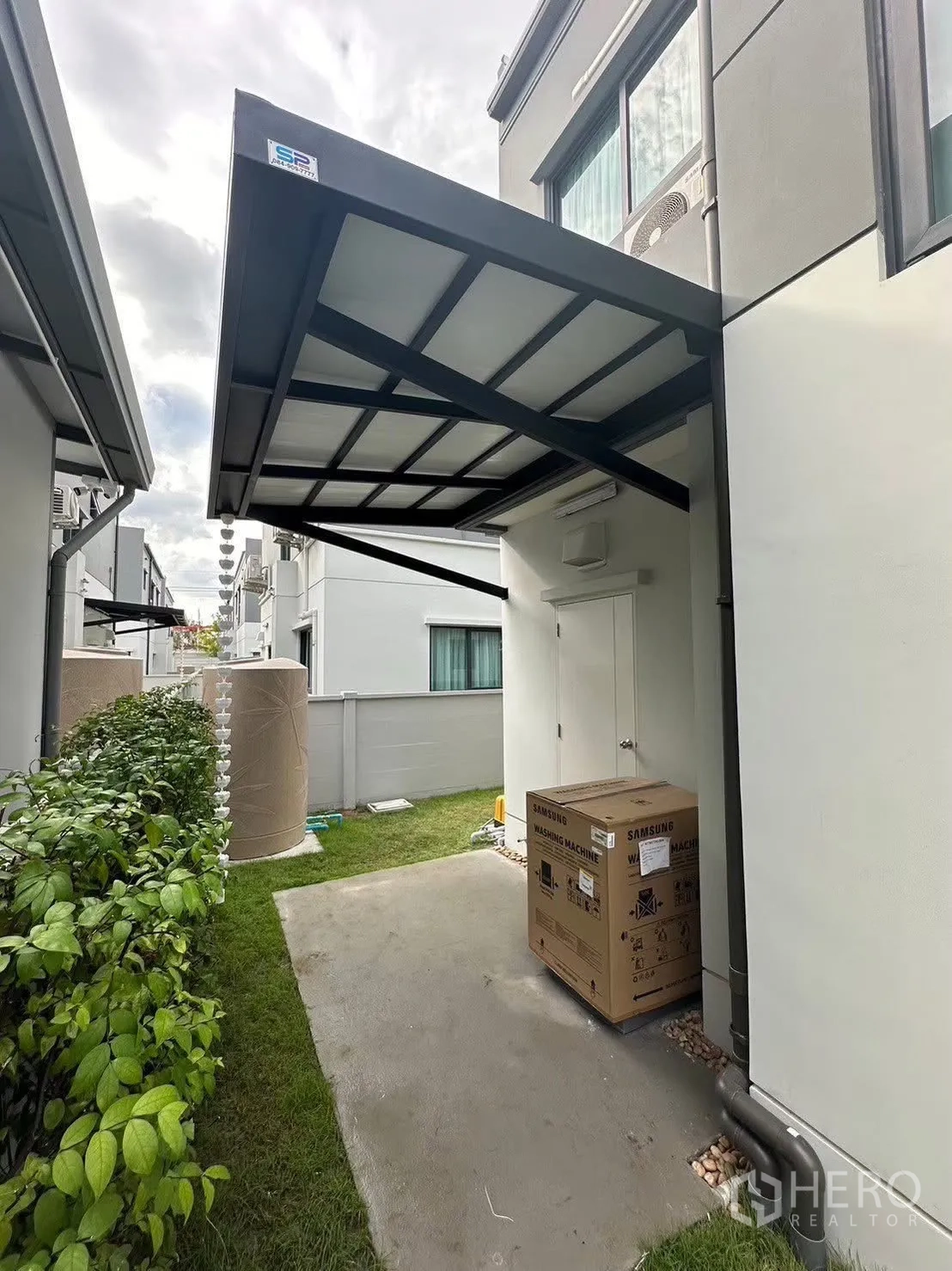 Detached House for rent in Bang Phli, Samut Prakan - Covered side utility area with concrete path, greenery and outdoor water tank.