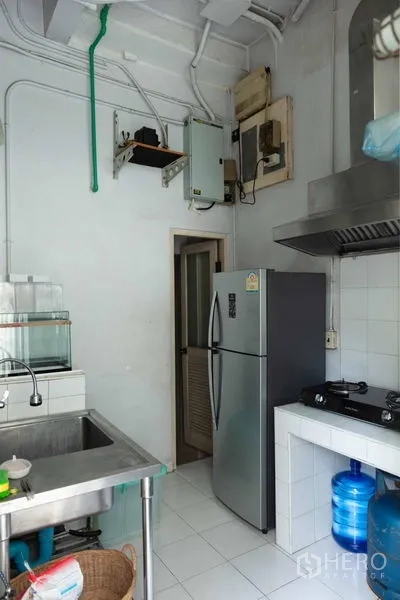 Townhouse for sale - Secondary Thai kitchen with stainless sink, stove hood and refrigerator.