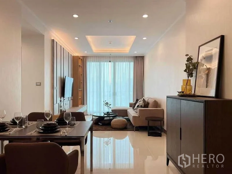 คอนโด ให้เช่าในWatthana, Bangkok - ห้องนั่งเล่นและรับประทานอาหารแบบโอเพ่นสเปซ สว่าง โปร่ง โซฟาเข้ามุม ผนังทีวี และประตูระเบียงกระจกเต็มบานพร้อมผ้าม่านโปร่ง