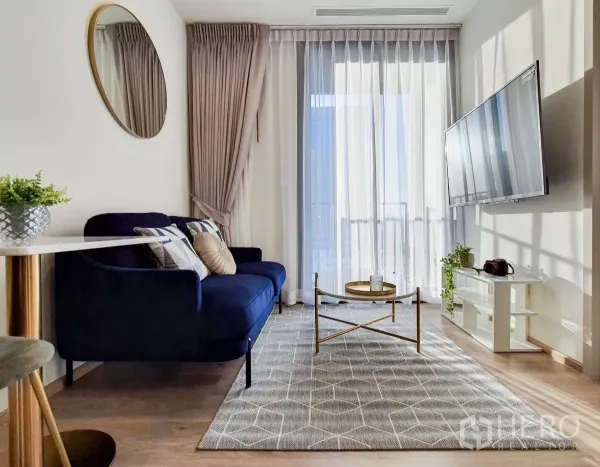 Condominium for rent in Khlong Toei, Bangkok - Bright lounge with floor‑to‑ceiling curtains, coffee table and sliding doors.