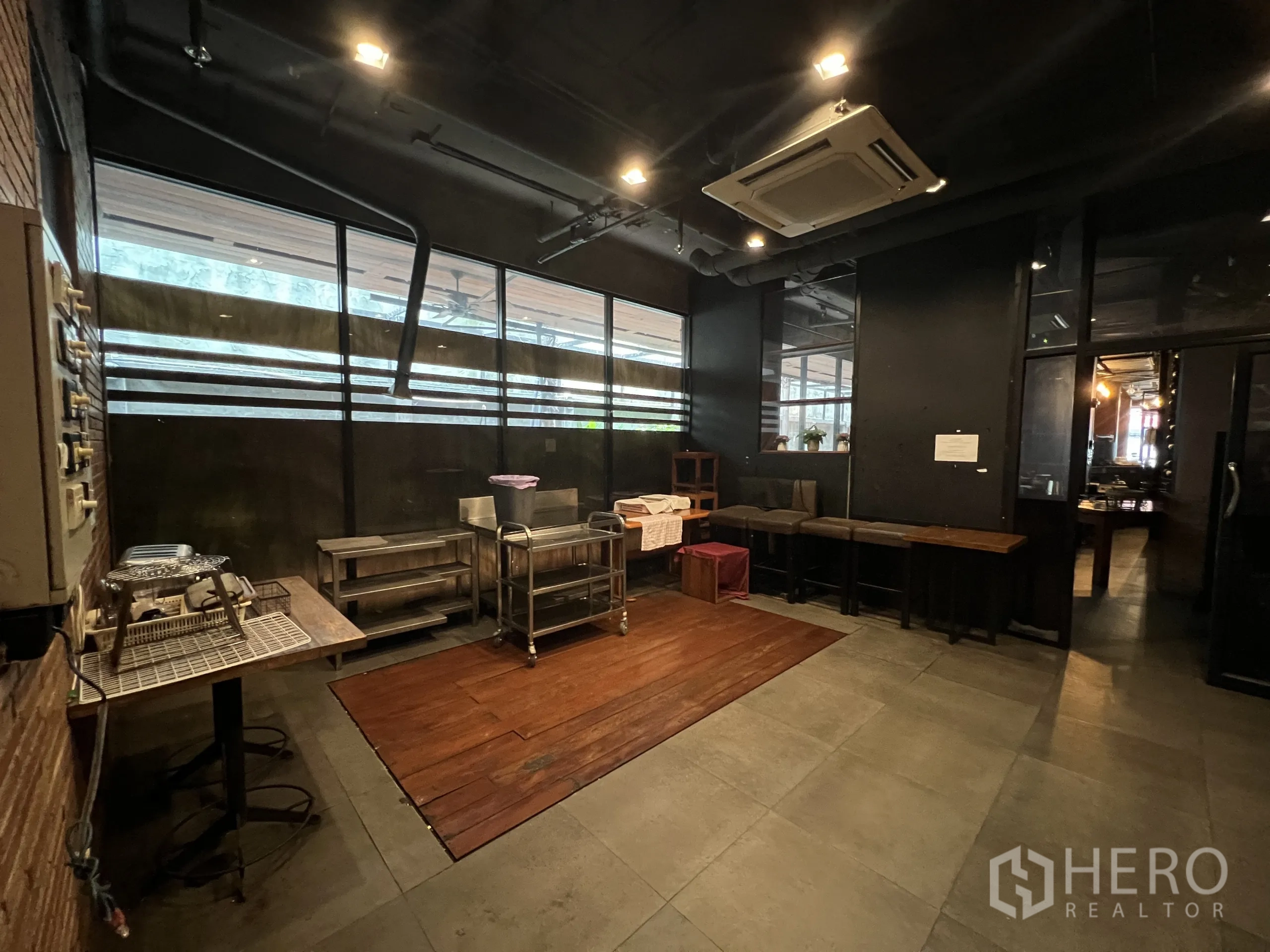 Retail Space for rent in Watthana, Bangkok - Spacious prep area with dark ceiling, cassette air conditioning, and corridor windows.