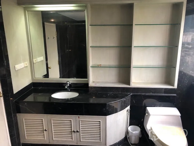 Condominium for sale - Bathroom with black granite vanity, large mirror and open shelving.