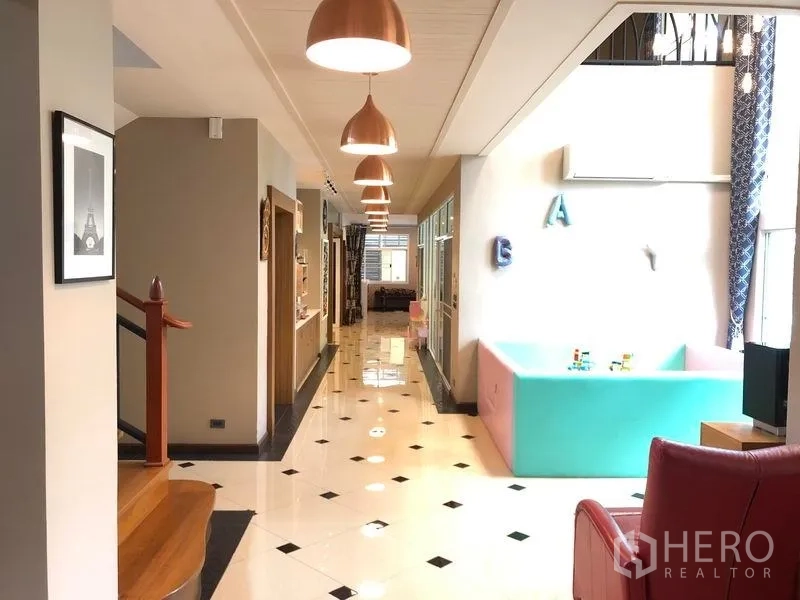 Detached House for sale in Wang Thonglang, Bangkok - Bright hallway with high ceiling, pendant lights and a wooden staircase.