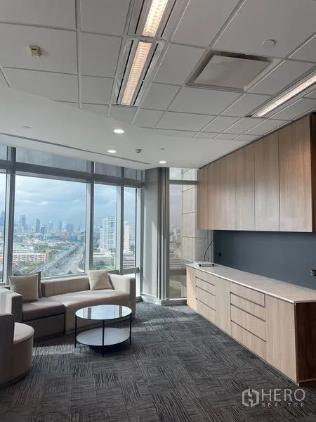 Office Space for rent in Dusit, Bangkok - Executive lounge with pantry cabinets, sofa seating and full-height glass overlooking Bangkok.