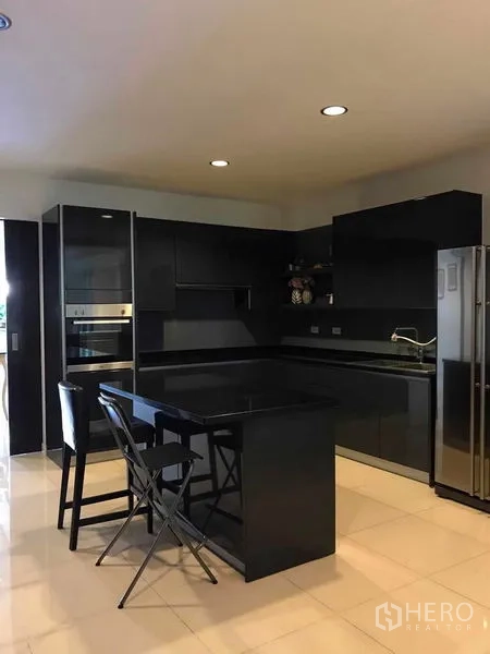 Detached House for sale in Wang Thonglang, Bangkok - Contemporary black kitchen with island, built-in oven and large refrigerator