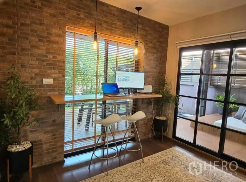 Detached House for rent in Bang Phli, Samut Prakan - Brick-accent work nook with bar-height desk, pendant lights and view to terrace