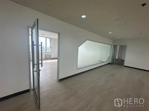 Office Space for rent - Private office featuring an internal angled glass window and hinged glass door within a modern workspace.