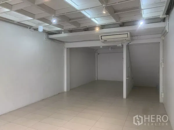 Retail Space for rent in Yan Nawa, Bangkok - Retail unit showing spacious layout with AC, spotlight ceiling and stair nook to upper level.