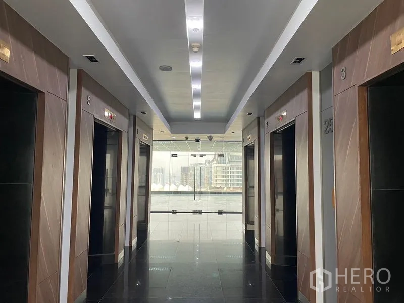 Office Space for rent in Din Daeng, Bangkok - Modern elevator lobby with multiple lifts and a city outlook.
