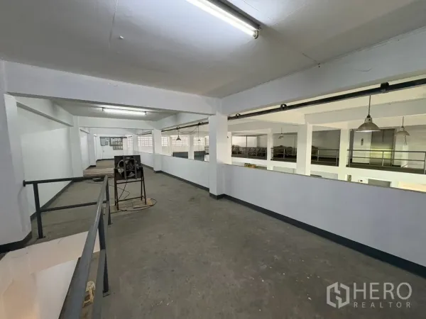Warehouse for rent in Bang Na, Bangkok - Long mezzanine corridor with railings above the main floor.