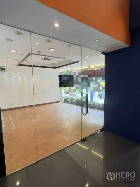 Retail Space for rent in Pathum Wan, Bangkok - Glass entrance door opening to bright shop space with laminated floors and spotlights.