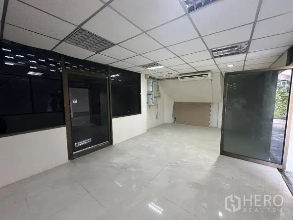 Home Office for rent in Taling Chan, Bangkok - Glass-partitioned reception or office room with tiled floor and wall-mounted air conditioner.