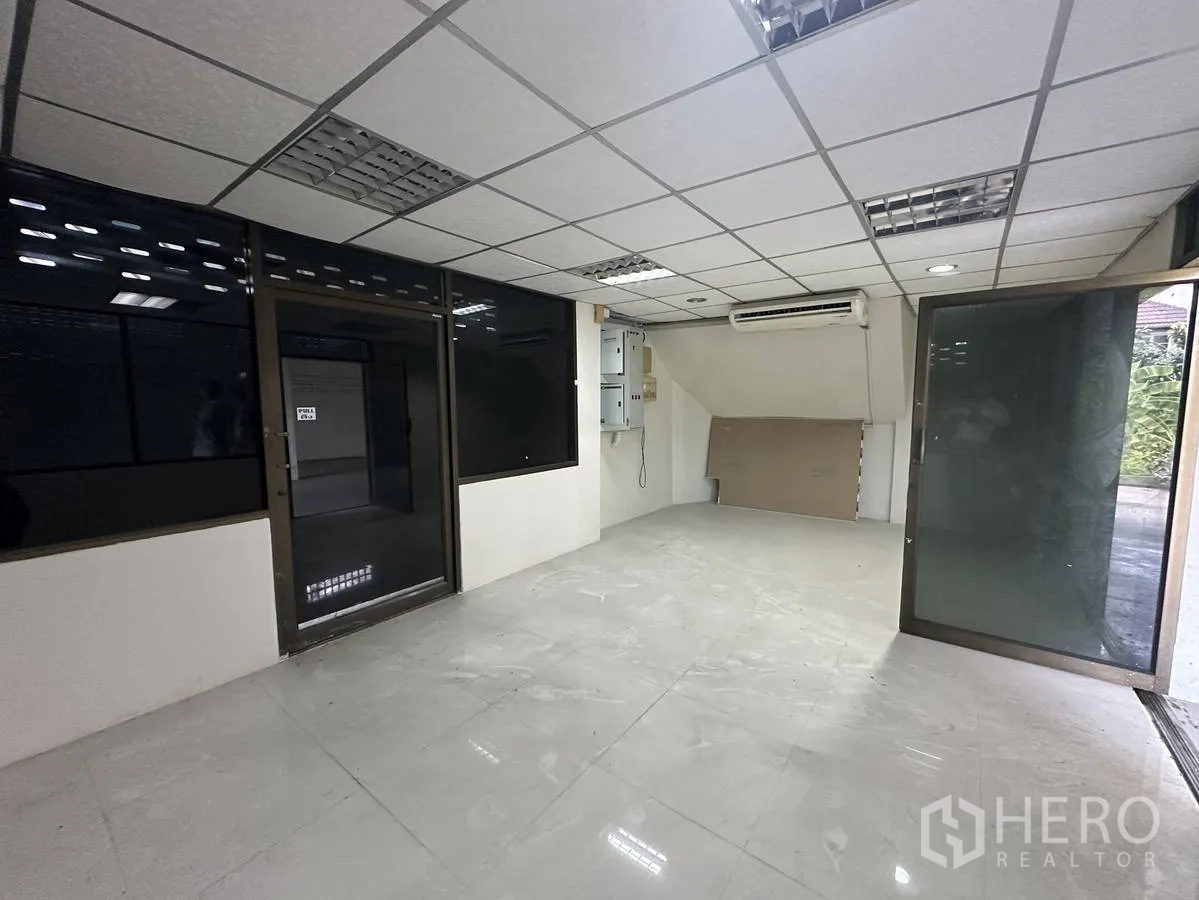 Home Office for rent in Taling Chan, Bangkok - Glass-partitioned reception or office room with tiled floor and wall-mounted air conditioner.