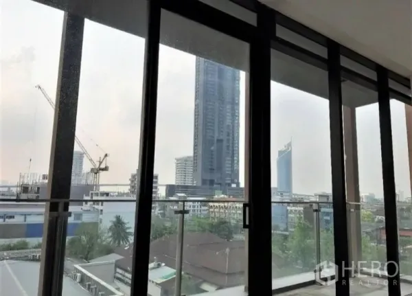 Office Space for rent in Bang Kho Laem, Bangkok - City skyline view through large glass panels from the office interior.