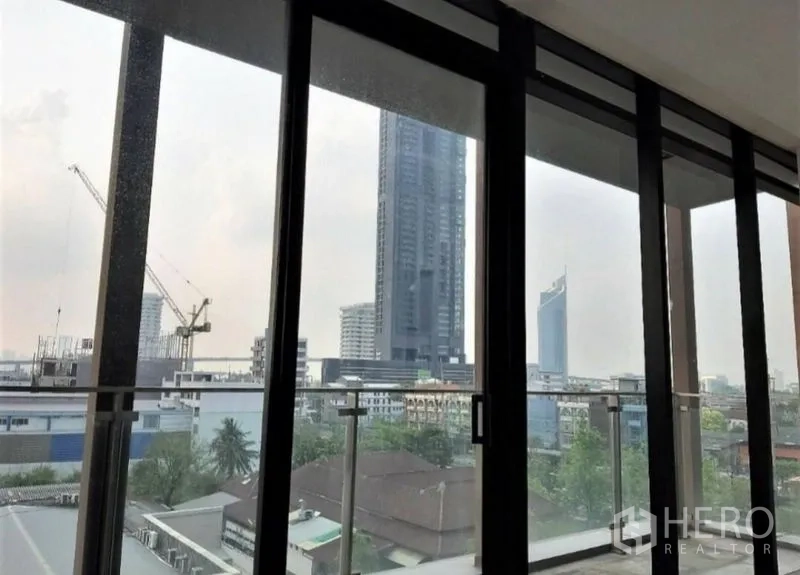 Office Space for rent in Bang Kho Laem, Bangkok - City skyline view through large glass panels from the office interior.