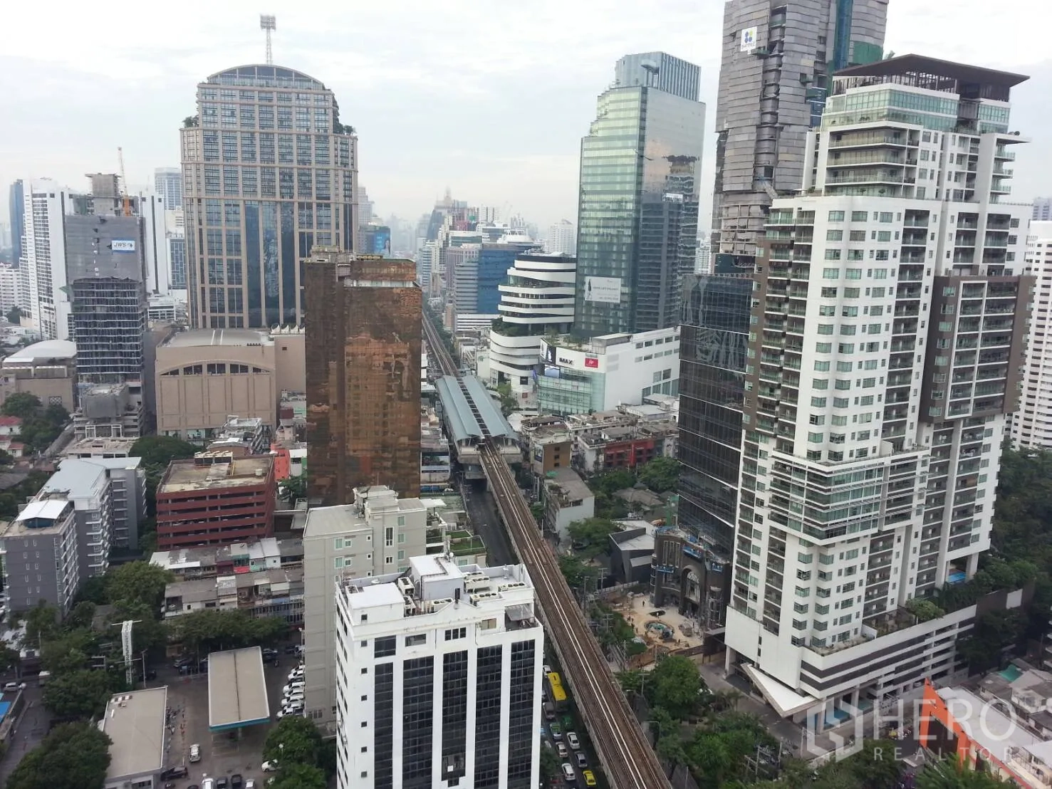 Condominium for rent or sale in Khlong Toei, Bangkok - High-floor city view showing the BTS Skytrain line and surrounding Sukhumvit towers.
