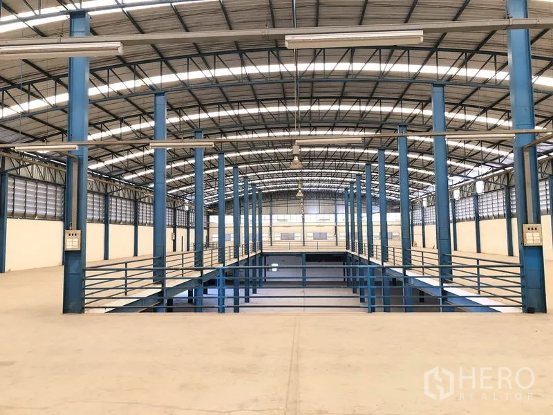 Factory for rent in Sai Noi, Nonthaburi - Mezzanine walkway overlooking central void under a high roof for additional storage.