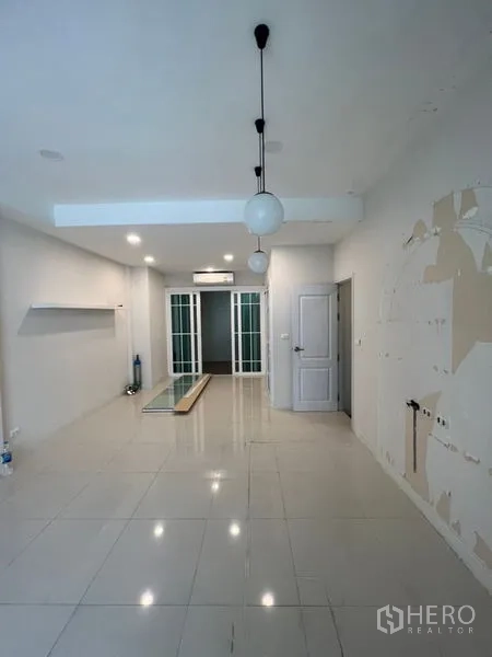 Home Office for rent - Ground-floor reception space with glossy tile floor, pendant lights, and sliding glass doors.