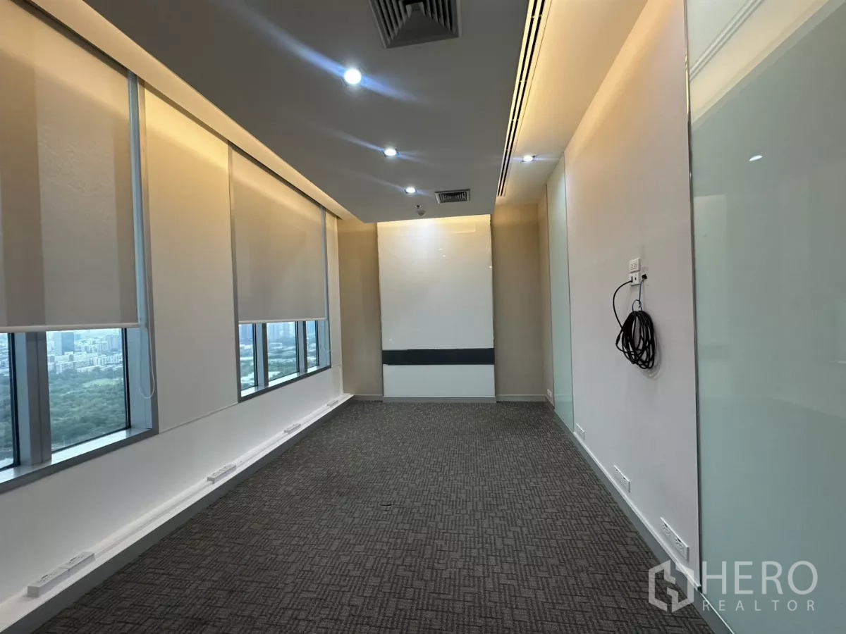Office Space for rent in Watthana, Bangkok - Bright meeting room with floor-to-ceiling windows, roller blinds and skyline view.
