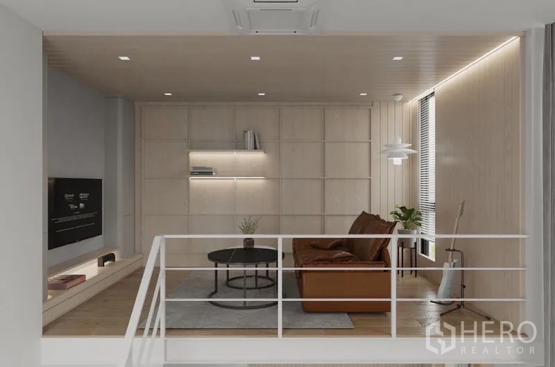 Detached House for rent in Saphan Sung, Bangkok - Mezzanine family lounge with leather sofa, light‑wood paneling and built‑in shelves.