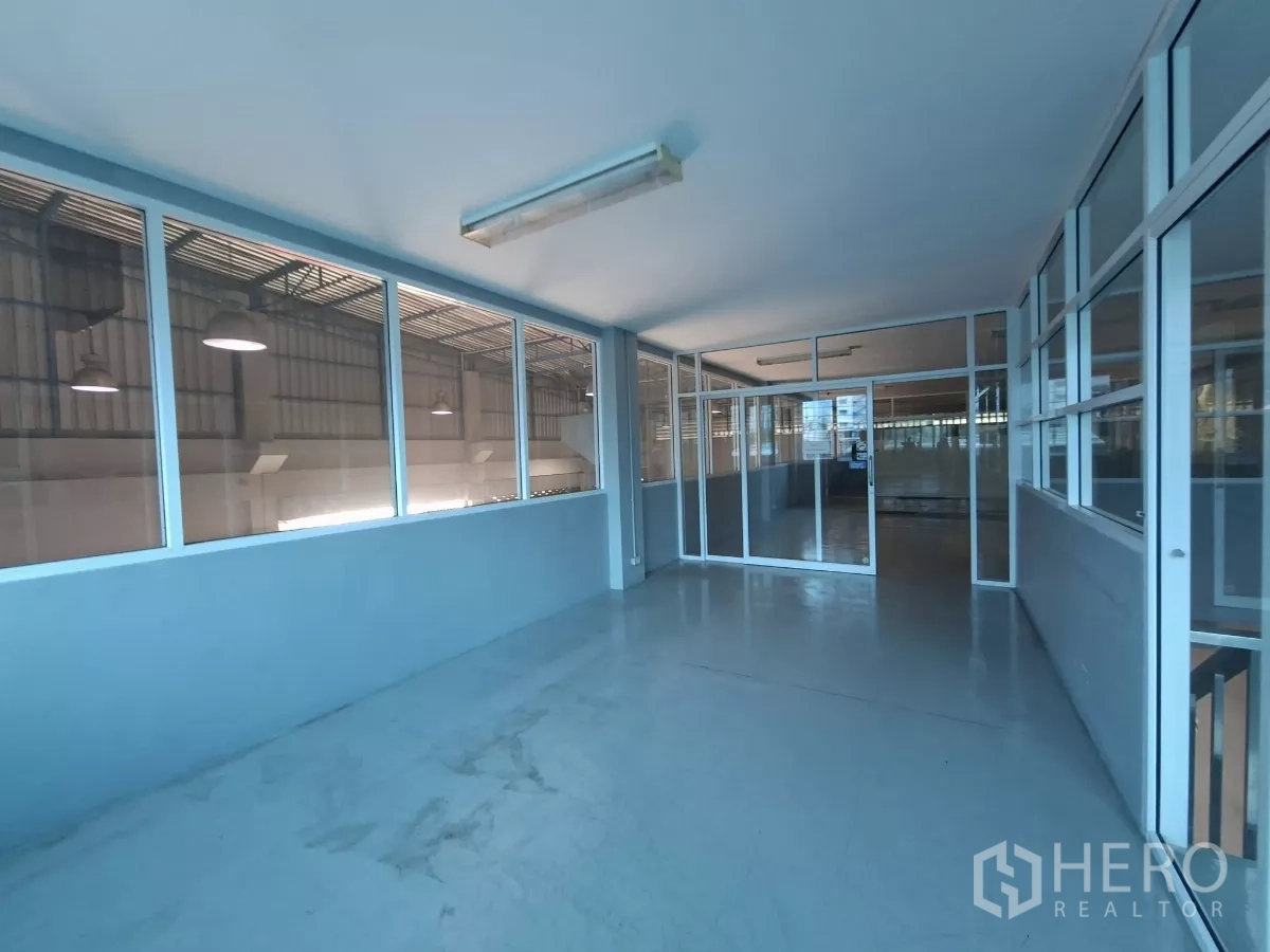 Warehouse for rent in Suan Luang, Bangkok - Second‑floor office corridor with glass partitions overlooking the warehouse below.