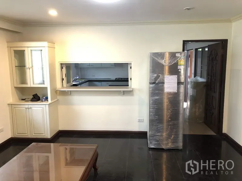 Detached House for rent in Khan Na Yao, Bangkok - Family room with serving hatch to the kitchen, display cabinet and a new stainless refrigerator.