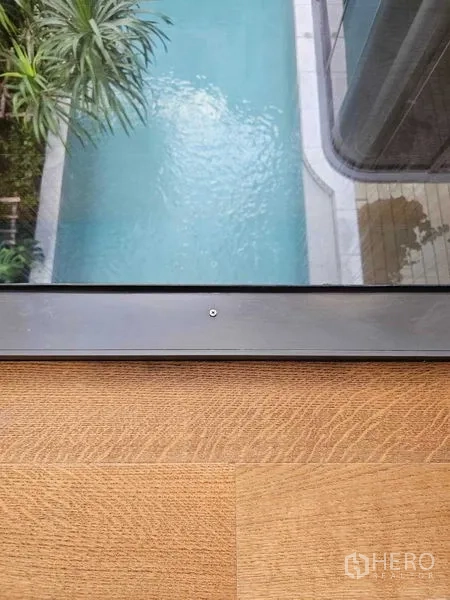 Detached House for rent in Wang Thonglang, Bangkok - Aerial view from a window looking down to the turquoise swimming pool and deck.