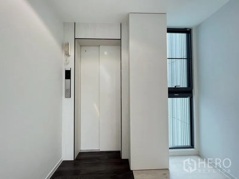 Detached House for rent or sale in Saphan Sung, Bangkok - Private home lift in a bright hallway with side window.