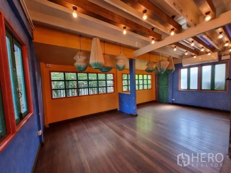 Detached House for rent in Khlong Toei, Bangkok - Bright multipurpose room with wide windows and decorative pendant lights.