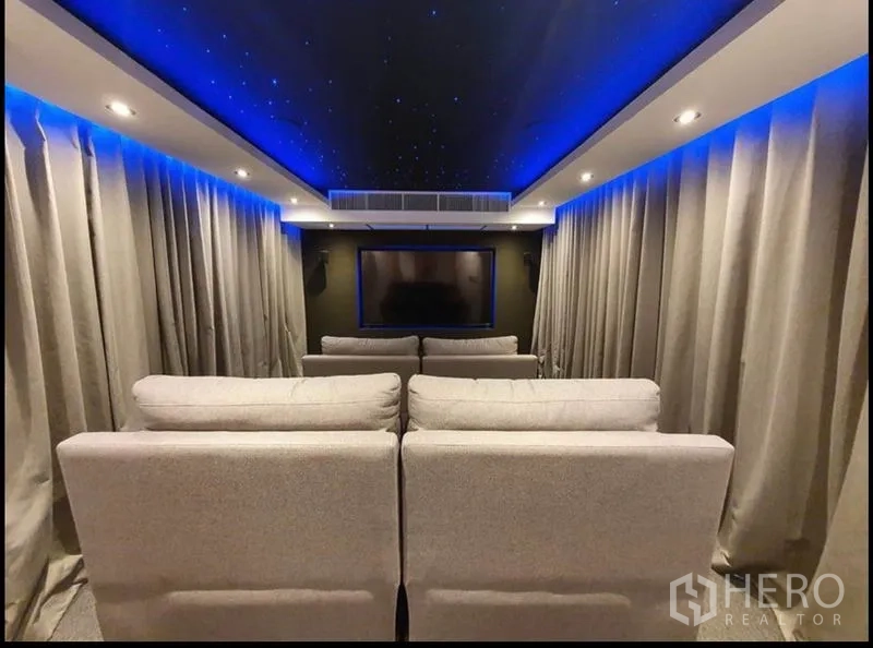 Condominium for rent in Watthana, Bangkok - Home theater facing the screen with reclining seats and blue star-lit ceiling.