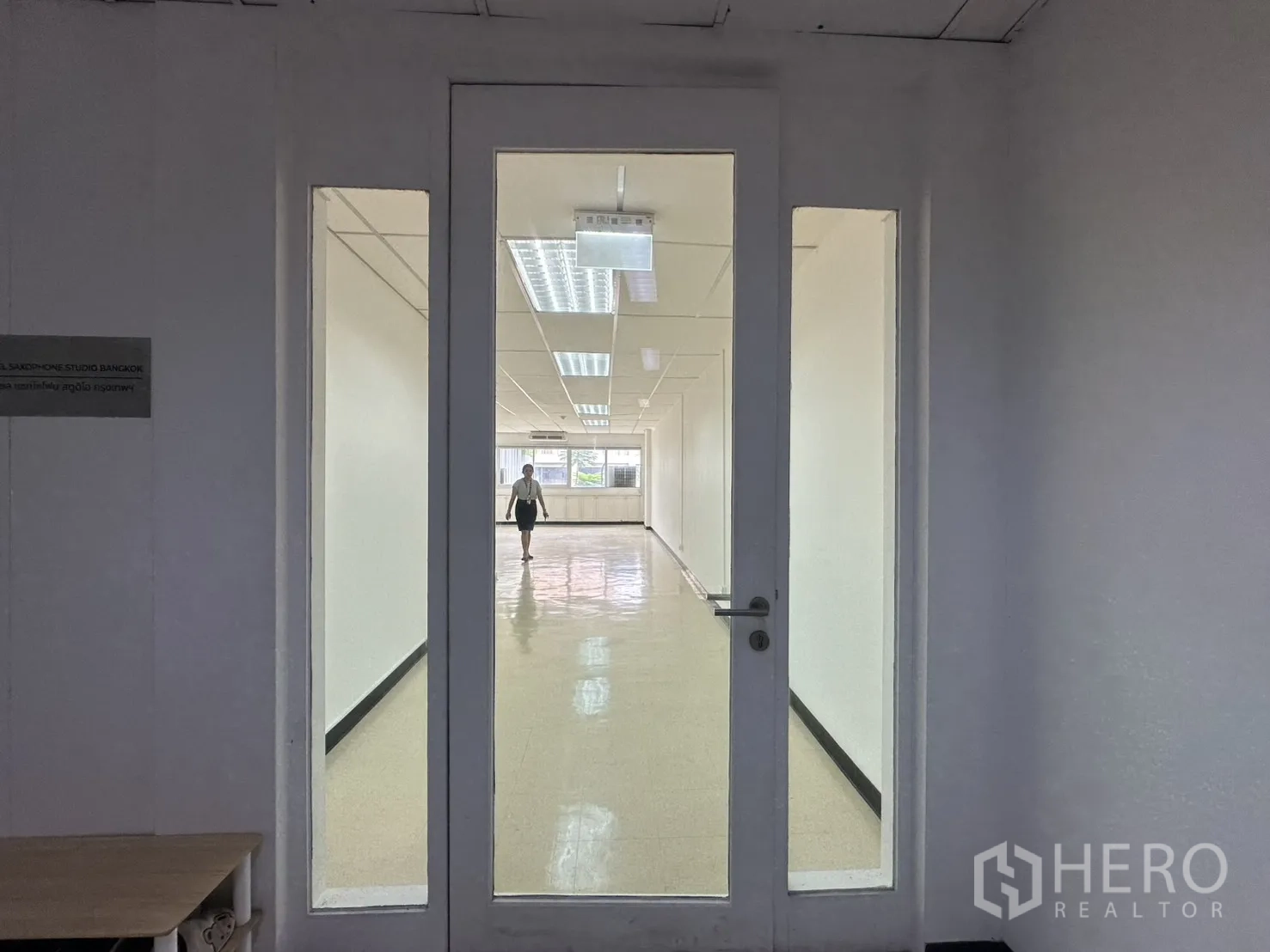 Office Space for rent in Pathum Wan, Bangkok - Glass entry door with sidelights opening into a long open-plan office interior.