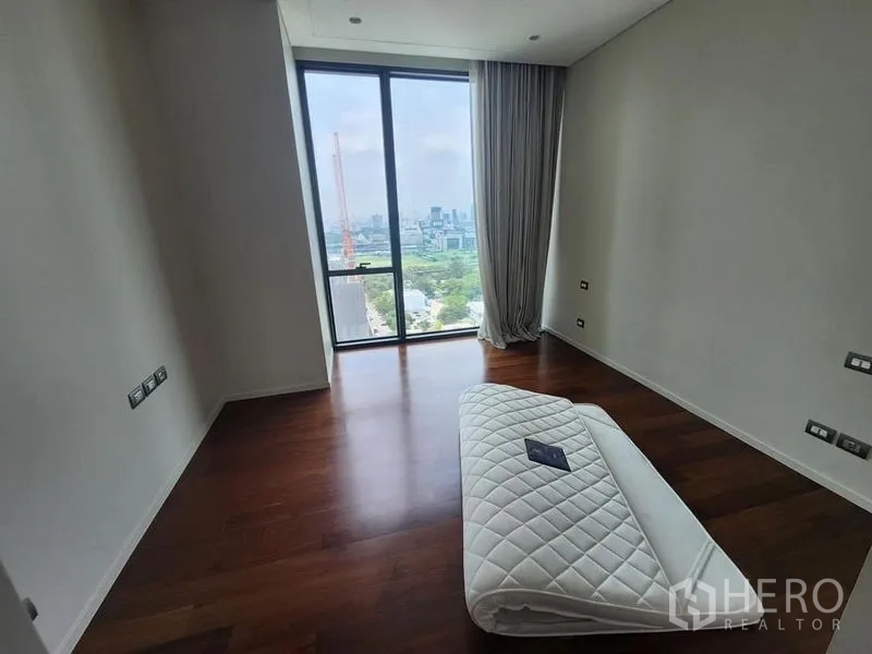 Condominium for sale - Bedroom with floor-to-ceiling window, hardwood floors, and panoramic city and park views.
