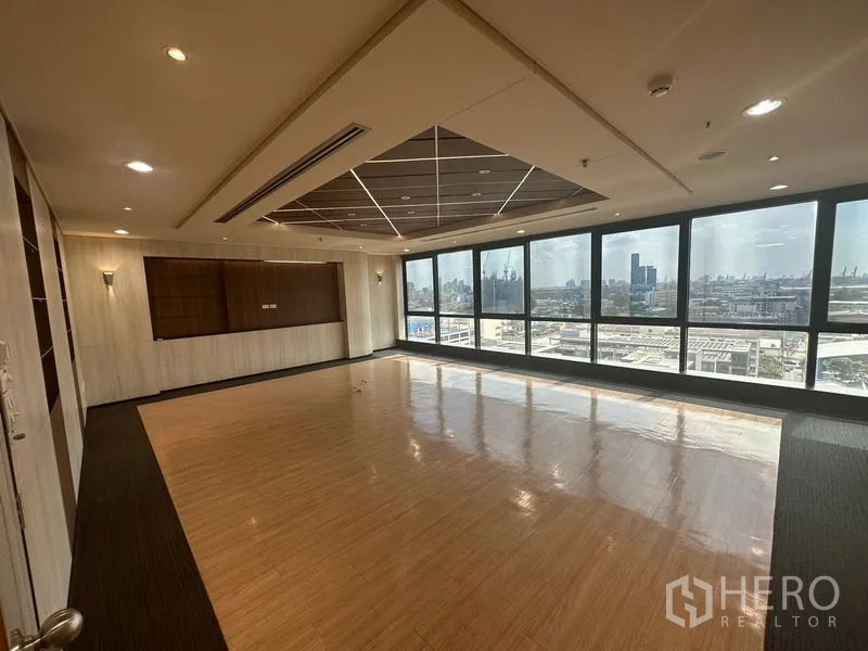 Office Space for rent in Khlong Toei, Bangkok - Executive meeting room with polished wood floor, coffered ceiling, and far-reaching city views.