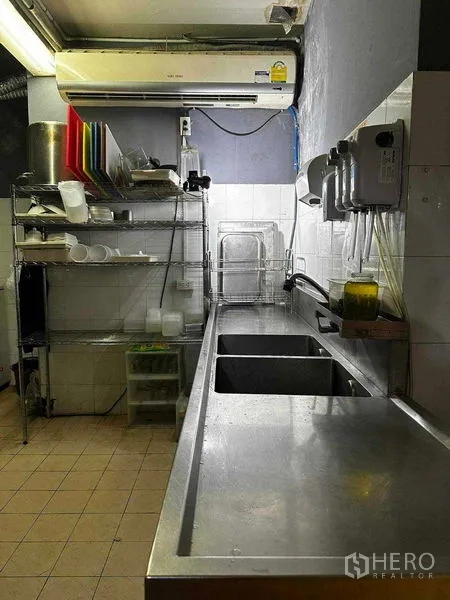 Retail Space for rent in Watthana, Bangkok - Long stainless worktop and double sink in a tiled kitchen.