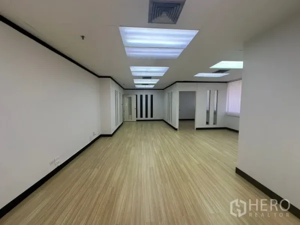 办公空间 出租在Yan Nawa, Bangkok - 狭长工作区，嵌入式灯板、木纹地面，多个通往独立办公室的门
