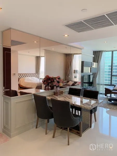 Condominium for sale - Dining area facing lounge and full-height windows for natural light.